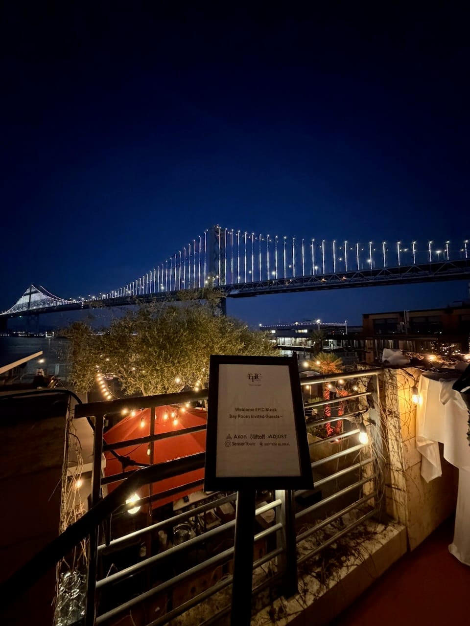 Bay Bridge view from EPIC Steak, with the welcome sign from the co-hosts